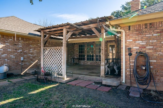 exterior space with roof with shingles, a chimney, a pergola, and brick siding