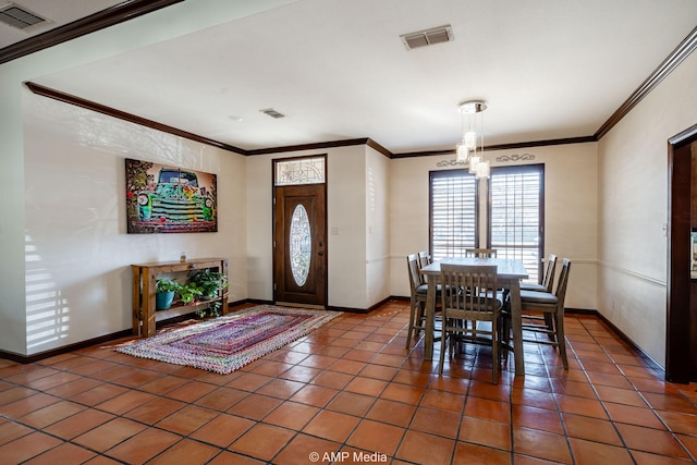 dining space with an inviting chandelier, tile patterned flooring, visible vents, and crown molding