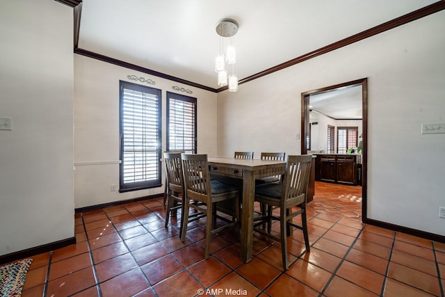 tiled dining room with baseboards, ornamental molding, and a healthy amount of sunlight