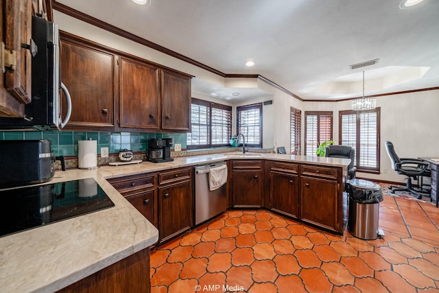 kitchen with visible vents, backsplash, appliances with stainless steel finishes, ornamental molding, and a peninsula