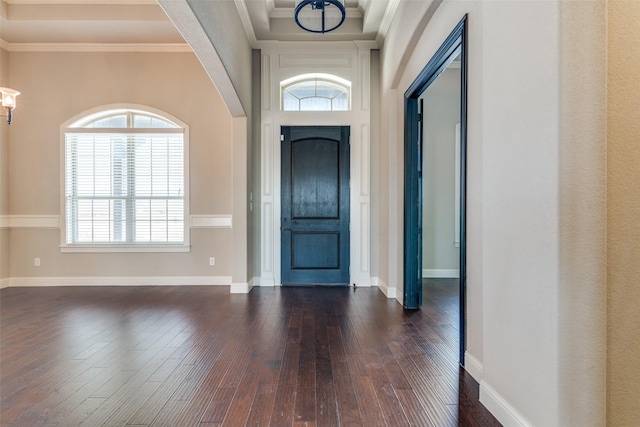 foyer with ornamental molding, dark wood-style flooring, and baseboards