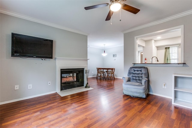 unfurnished living room featuring crown molding, a multi sided fireplace, and wood finished floors