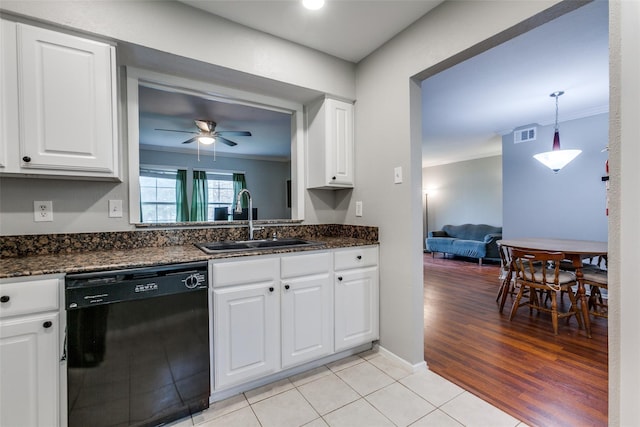 kitchen featuring black dishwasher, white cabinets, a ceiling fan, crown molding, and a sink