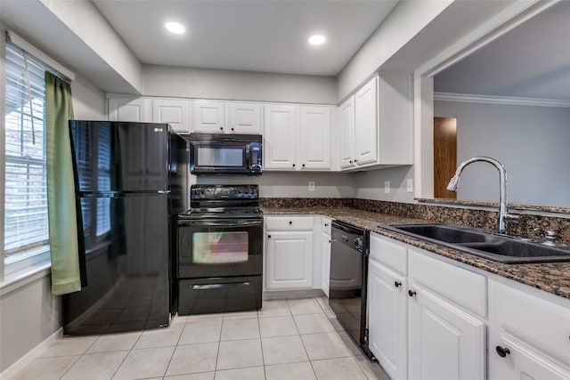 kitchen with light tile patterned floors, black appliances, a sink, and white cabinets