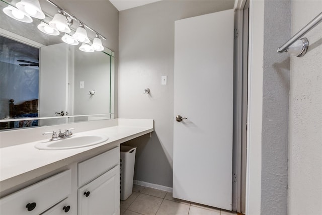 bathroom with vanity, baseboards, and tile patterned floors