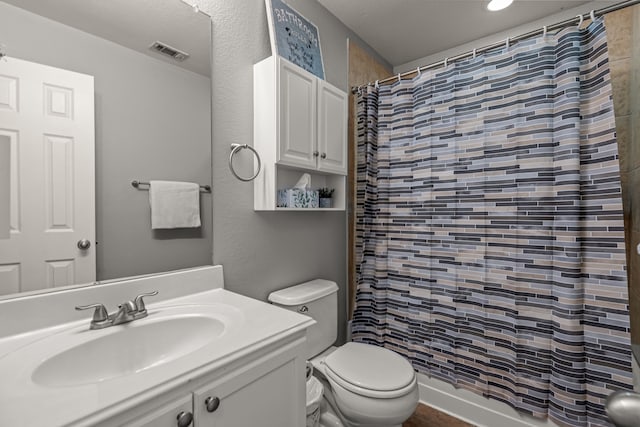 bathroom with toilet, visible vents, a shower with shower curtain, and vanity