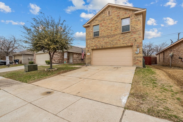 traditional home featuring a garage, driveway, brick siding, and fence