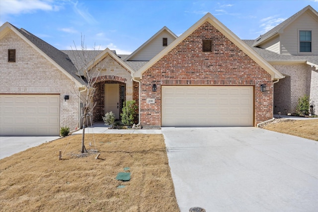 view of front of house featuring a garage, roof with shingles, concrete driveway, and brick siding