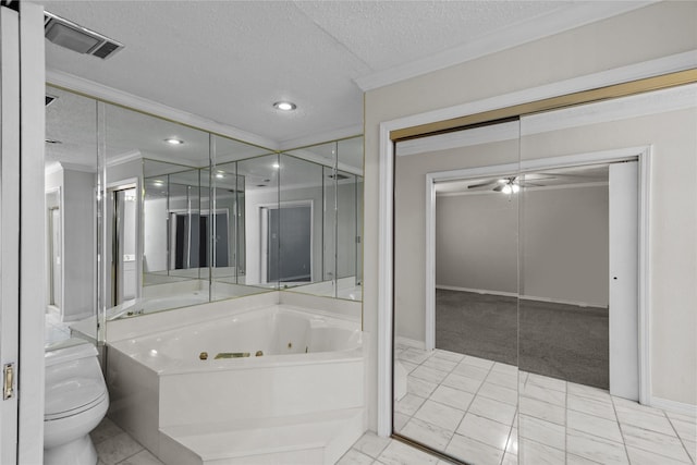 full bath featuring visible vents, toilet, a tub with jets, ornamental molding, and a textured ceiling