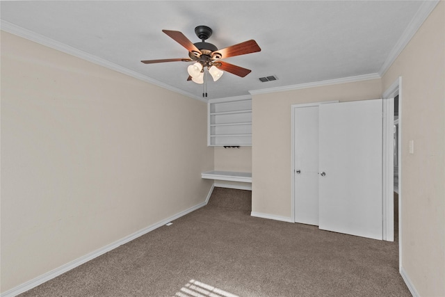 unfurnished bedroom with carpet floors, ornamental molding, visible vents, and baseboards