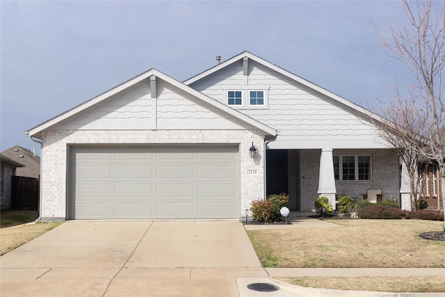 view of front of property with driveway, an attached garage, a front lawn, and brick siding