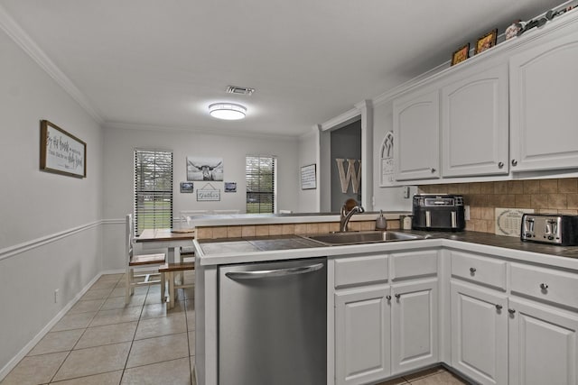 kitchen featuring light tile patterned floors, a peninsula, visible vents, white cabinets, and stainless steel dishwasher