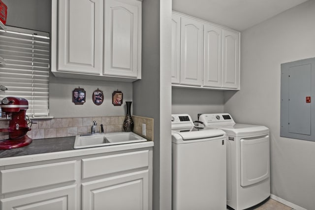 laundry area with washing machine and dryer, electric panel, indoor wet bar, and a sink