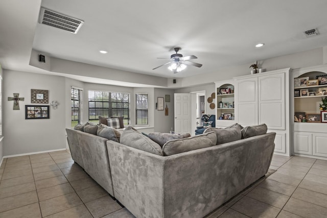 living room with light tile patterned floors, ceiling fan, and visible vents