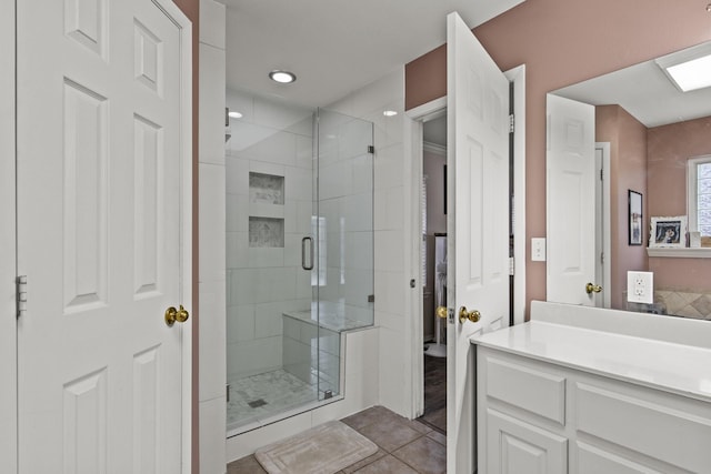 full bathroom featuring a shower stall, vanity, and tile patterned floors