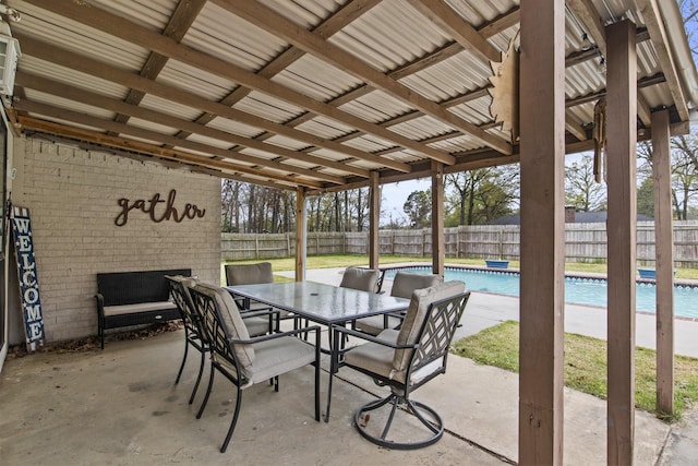 view of patio with a fenced in pool, outdoor dining space, and a fenced backyard