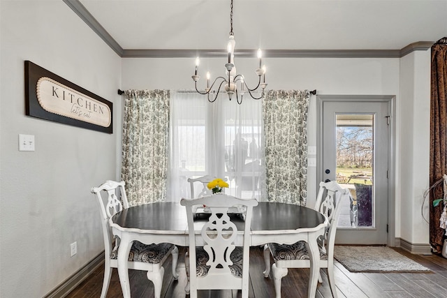 dining area with baseboards, an inviting chandelier, wood finished floors, and crown molding