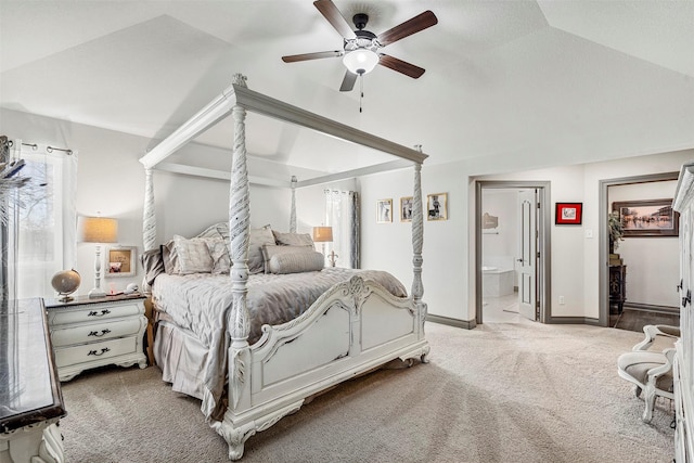 carpeted bedroom with lofted ceiling, baseboards, ceiling fan, and ensuite bath