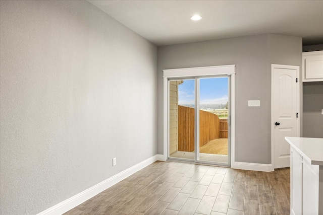 interior space featuring light wood finished floors, recessed lighting, and baseboards