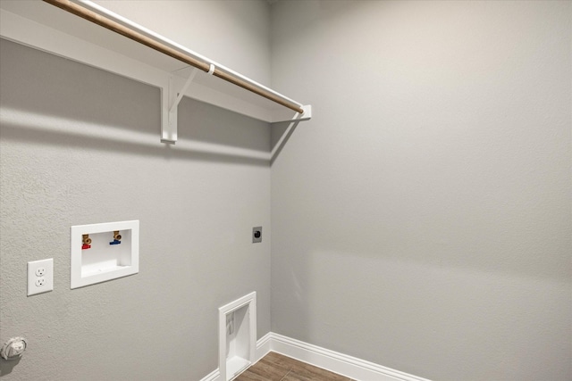 laundry area featuring dark wood finished floors, hookup for a washing machine, electric dryer hookup, laundry area, and baseboards