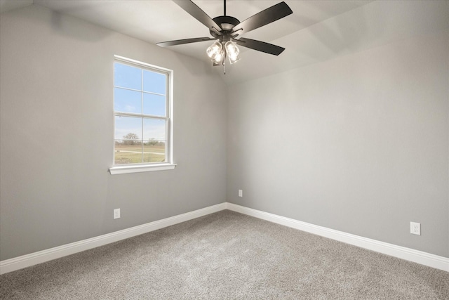 unfurnished room with vaulted ceiling, carpet flooring, a ceiling fan, and baseboards