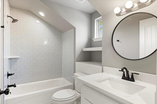 bathroom featuring a textured wall, shower / bathing tub combination, vanity, and toilet