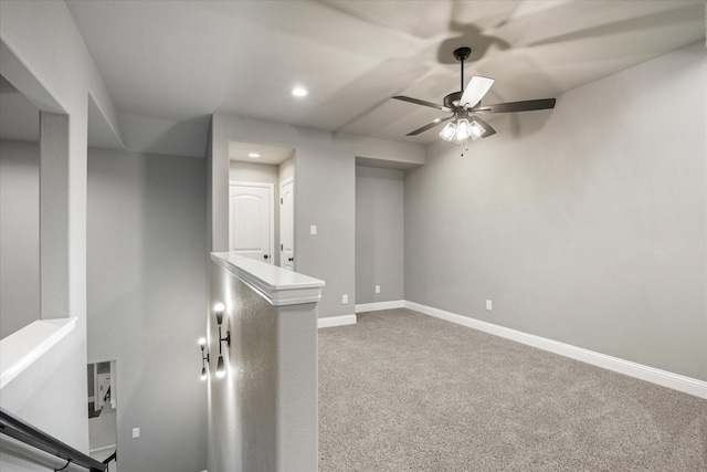 below grade area featuring a ceiling fan, carpet, baseboards, and recessed lighting