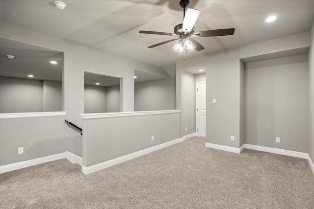 empty room with carpet floors, recessed lighting, and baseboards