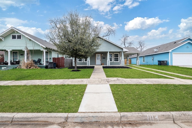 bungalow-style house featuring covered porch and a front lawn