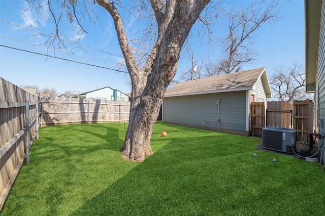 view of yard with a fenced backyard and central air condition unit