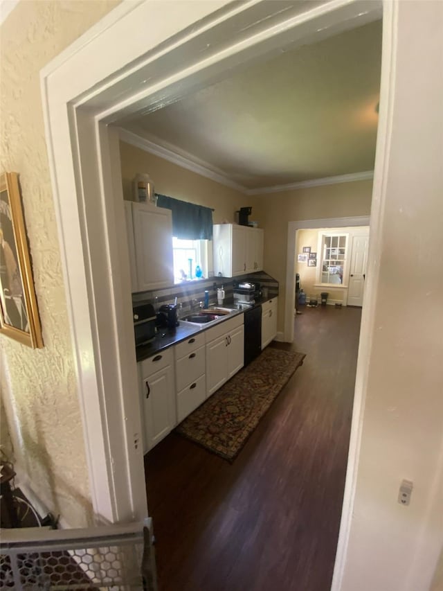 kitchen featuring crown molding, white cabinetry, dark wood-style flooring, and dishwasher