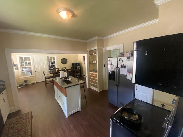 kitchen featuring crown molding, stainless steel fridge, black range with electric stovetop, and dark wood-style floors