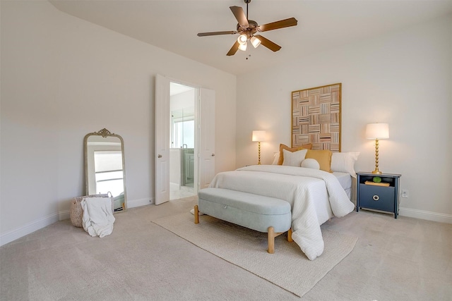 bedroom featuring a ceiling fan, light colored carpet, baseboards, and ensuite bathroom