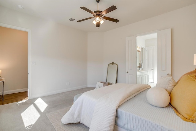 carpeted bedroom with visible vents, ceiling fan, and baseboards