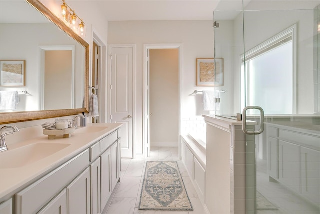 bathroom with marble finish floor, double vanity, a sink, and a shower stall