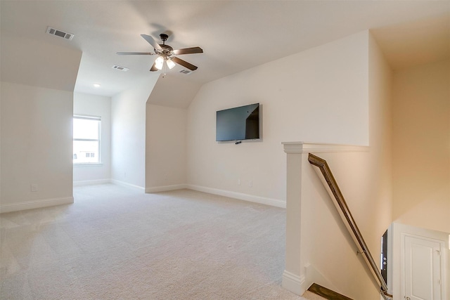 bonus room featuring baseboards, visible vents, vaulted ceiling, and light colored carpet