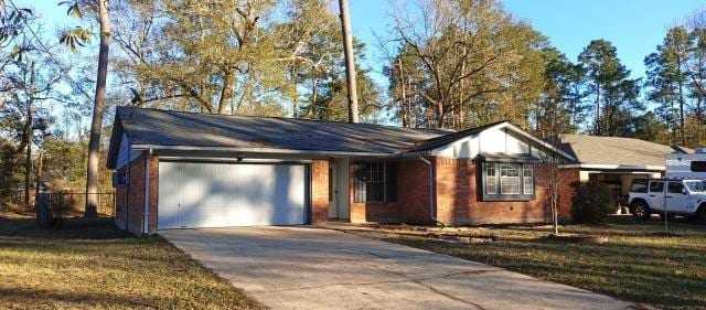 ranch-style home with a garage, driveway, and a front yard