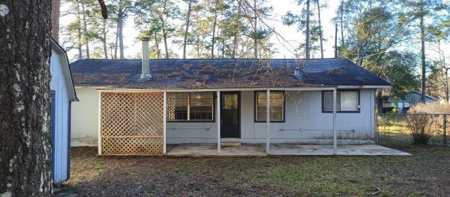 back of house with a patio and fence