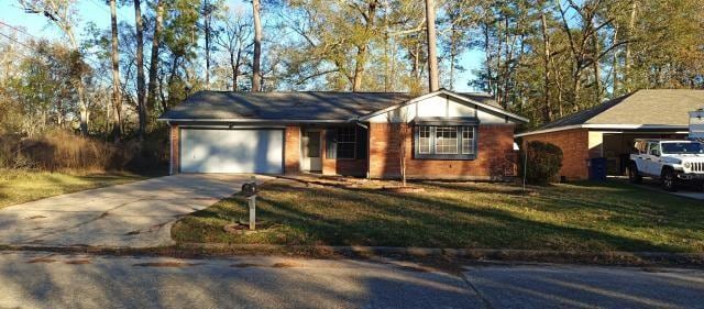 ranch-style home featuring a garage, driveway, and a front lawn