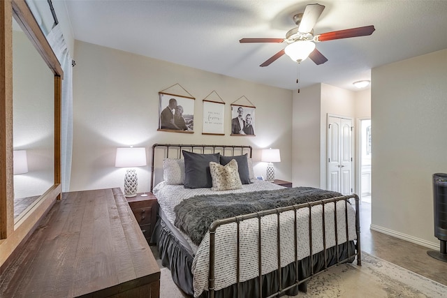 bedroom featuring concrete floors, a closet, baseboards, and a ceiling fan