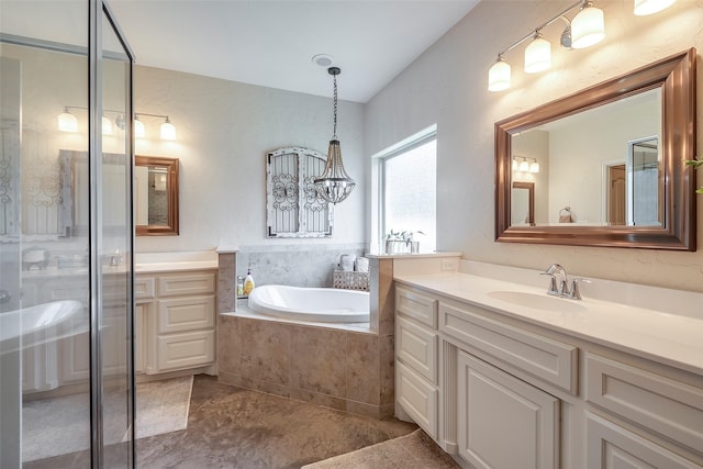 full bath featuring a garden tub, a shower stall, and vanity