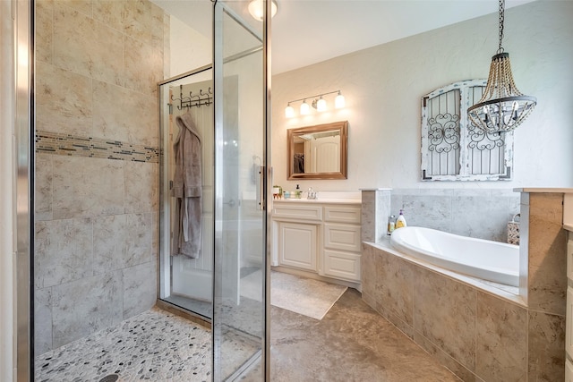 bathroom with a stall shower, vanity, and a bath