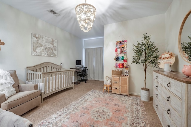 bedroom with a chandelier, a crib, carpet flooring, and visible vents