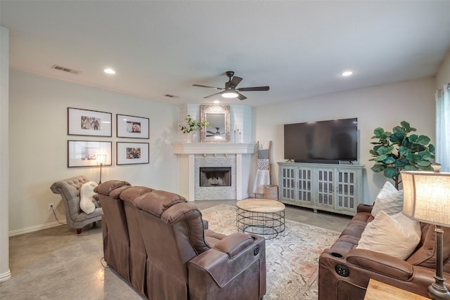 living room with a ceiling fan, recessed lighting, visible vents, and a fireplace