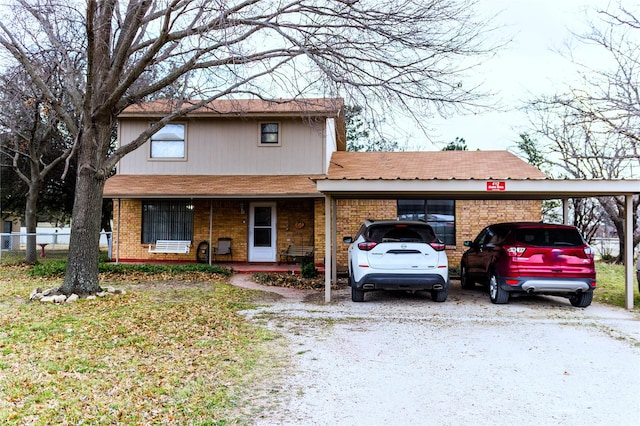 view of front of house with brick siding and fence