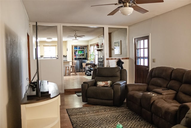 living area featuring a ceiling fan and wood finished floors