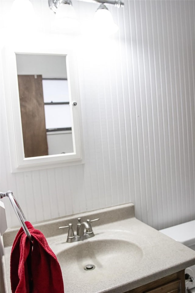 half bath featuring toilet and vanity