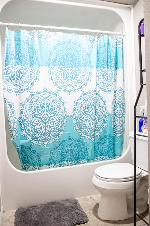 full bathroom with shower / tub combo, toilet, and tile patterned floors