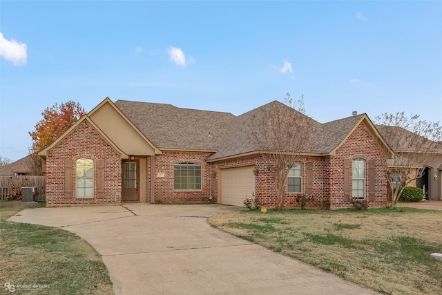 view of front facade with brick siding, roof with shingles, concrete driveway, an attached garage, and a front lawn