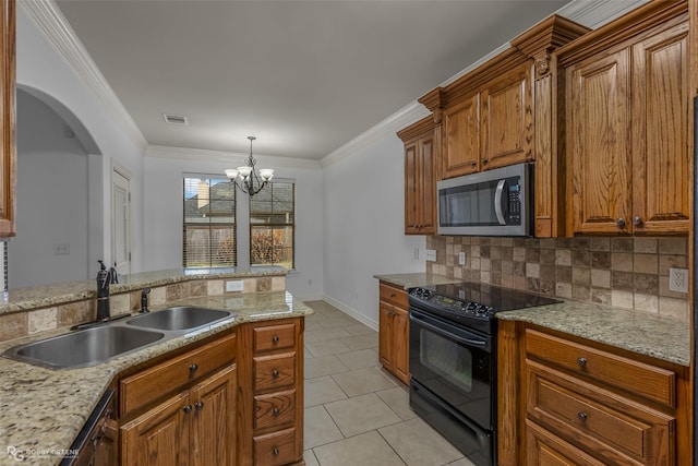 kitchen with visible vents, stainless steel microwave, brown cabinets, black range with electric stovetop, and a sink